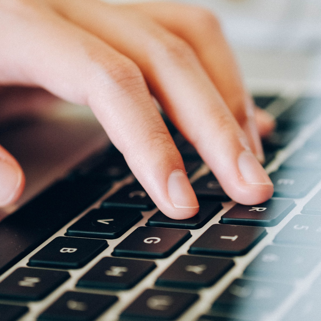 Hand on a computer keyboard as if typing