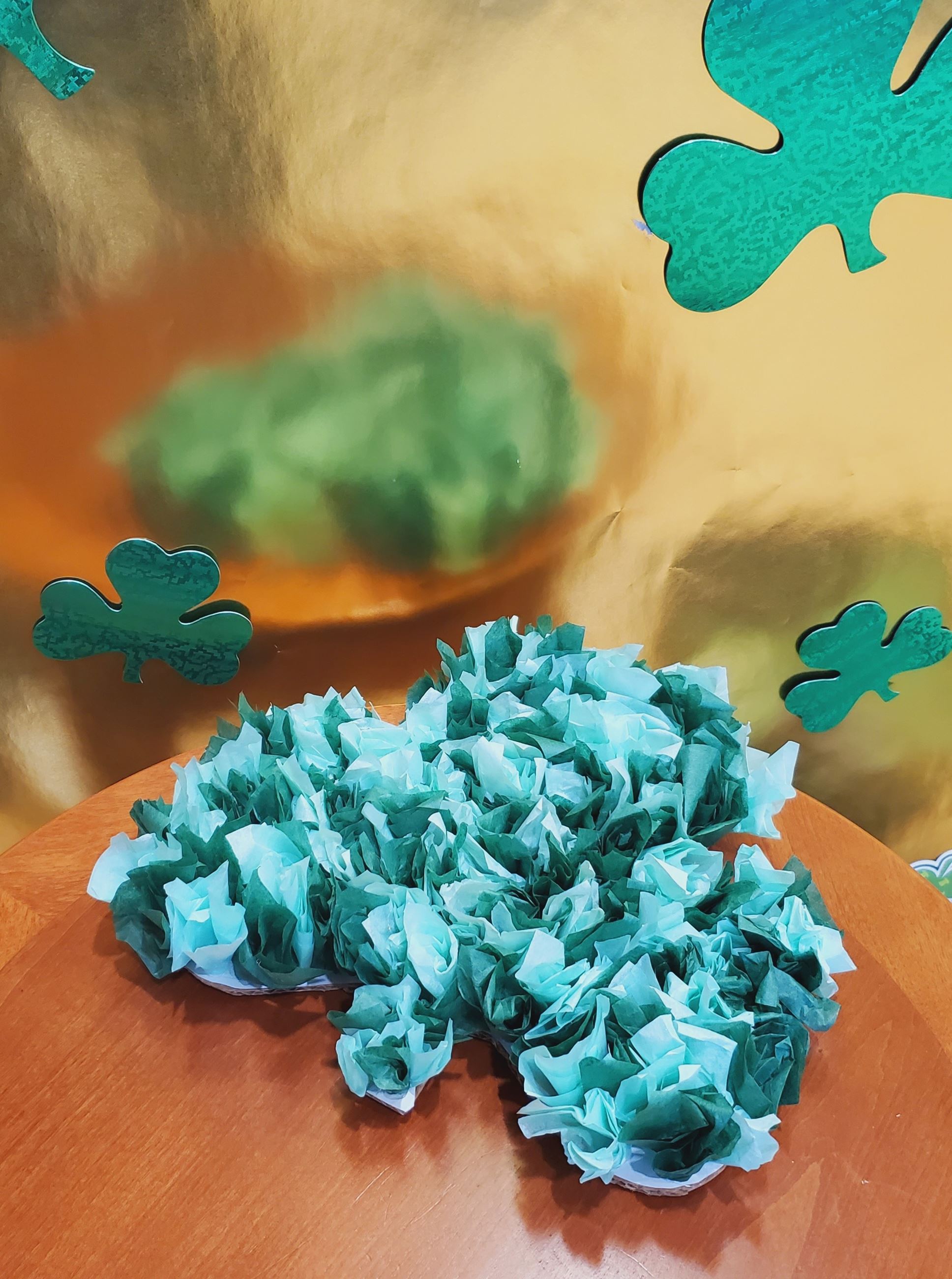 A shamrock made of varying shades of green tissue paper for the Shamrock Craft