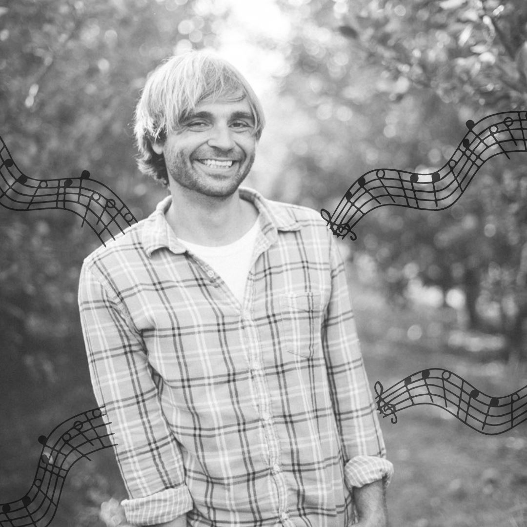 black and white photo of Jake Johnson with music notes.