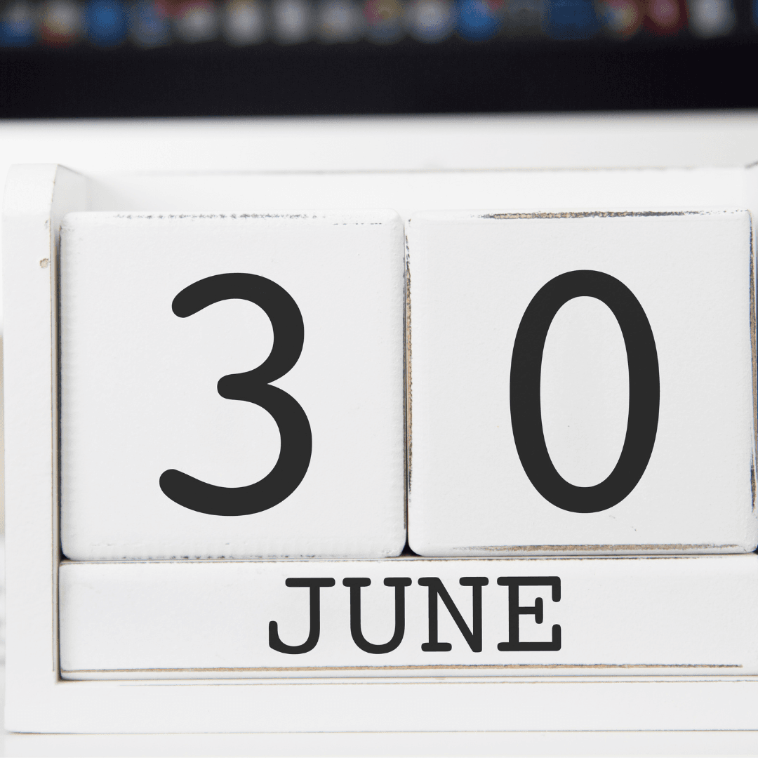 photo -Wood stand with the word JUNE on it and wooden blocks with the number three and zero atop it.