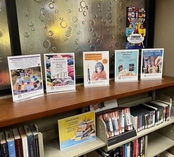 teen room bubble window with program signs, audiobooks, playaways on shelving 