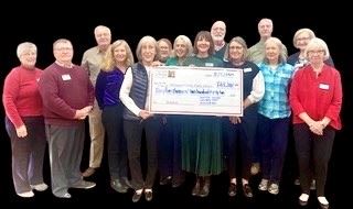 Photo of the check presentation to Director photo with Friends and Library Board members